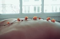Soft bokeh effect on a relaxing spa scene with delicate flowers on skin.